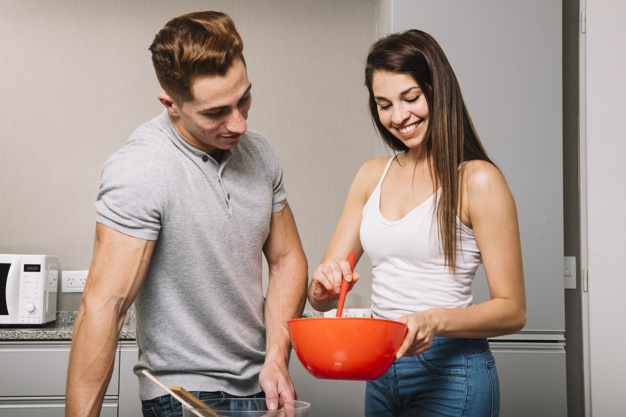 couple-cooking-together-in-kitchen_23-2147992135.jpg